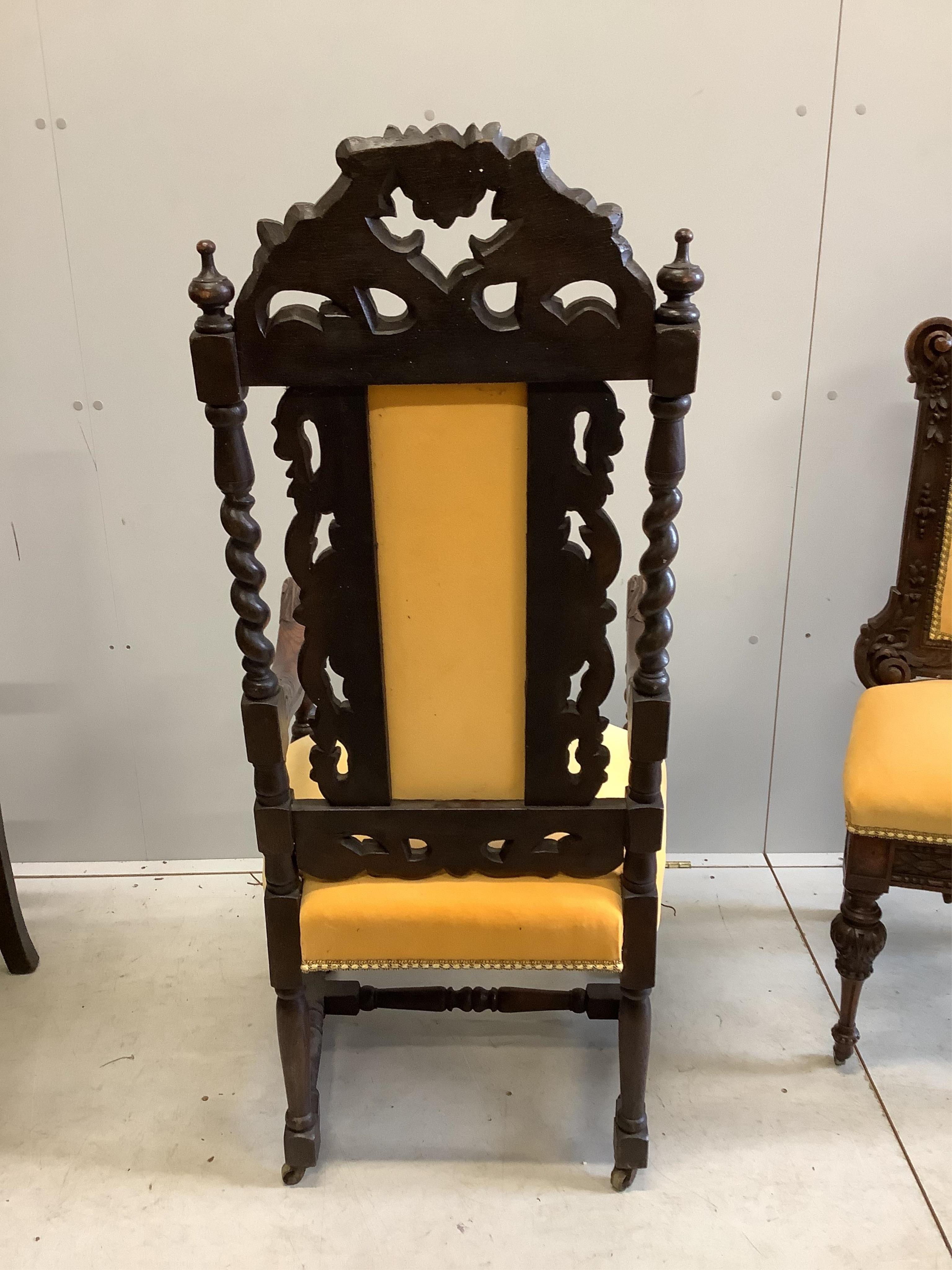 Two late 19th century Flemish carved oak dining chairs, one with arms, together with a Spanish style oak and leather elbow chair. Condition - fair to good